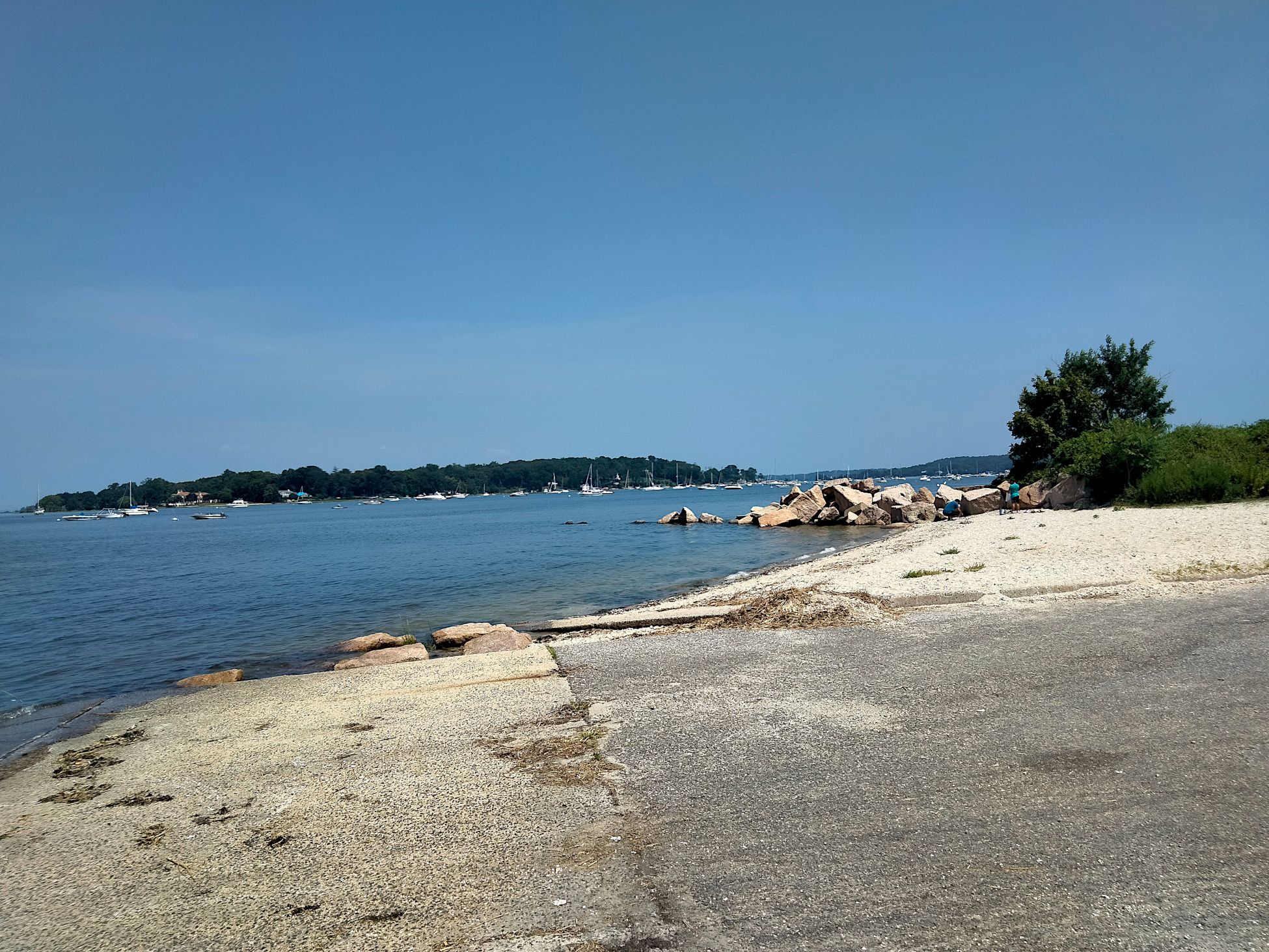 view of the rocks and boats at sea.png