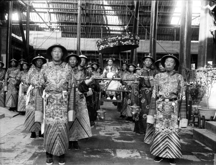 Qing Dynasty_Cixi_Imperial_Dowager_Empress_of_China_On_Throne_Sedan_With_Palace_Enuches.jpg