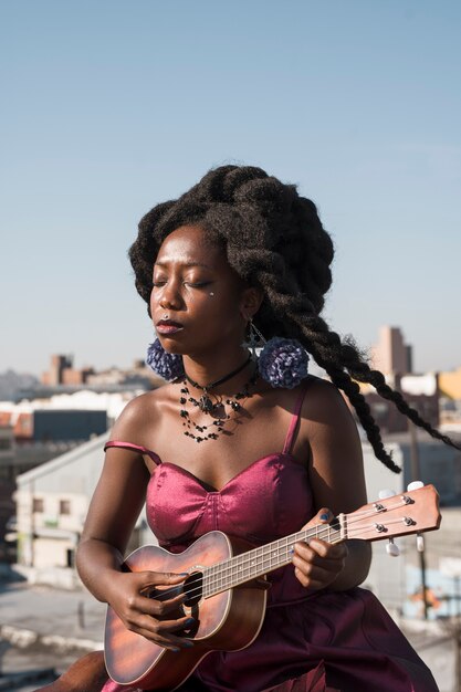 medium-shot-woman-playing-ukulele_23-2149223653.jpg