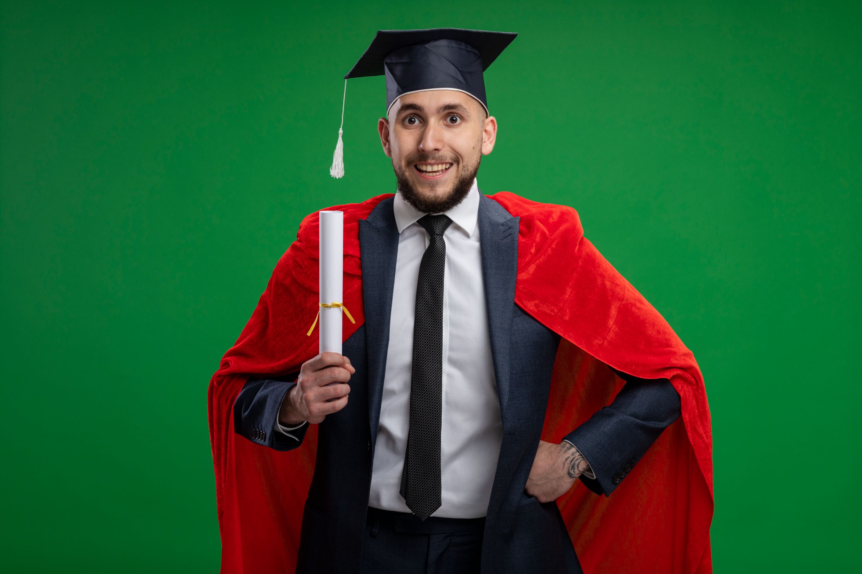 graduated-man-red-cape-holding-diploma-happy-cheerful-smiling-standing-green-wall.jpg