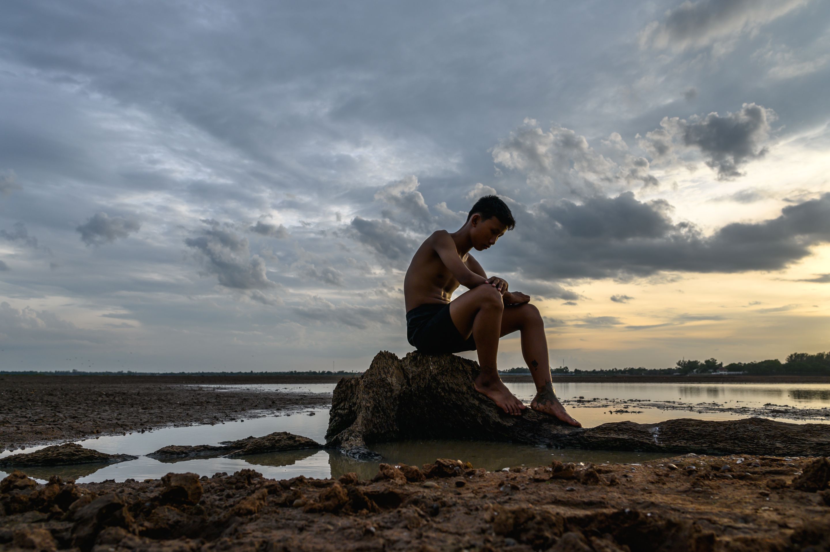 man-sat-bent-his-knees-base-tree-where-floor-was-dry-hands-placed-head.jpg