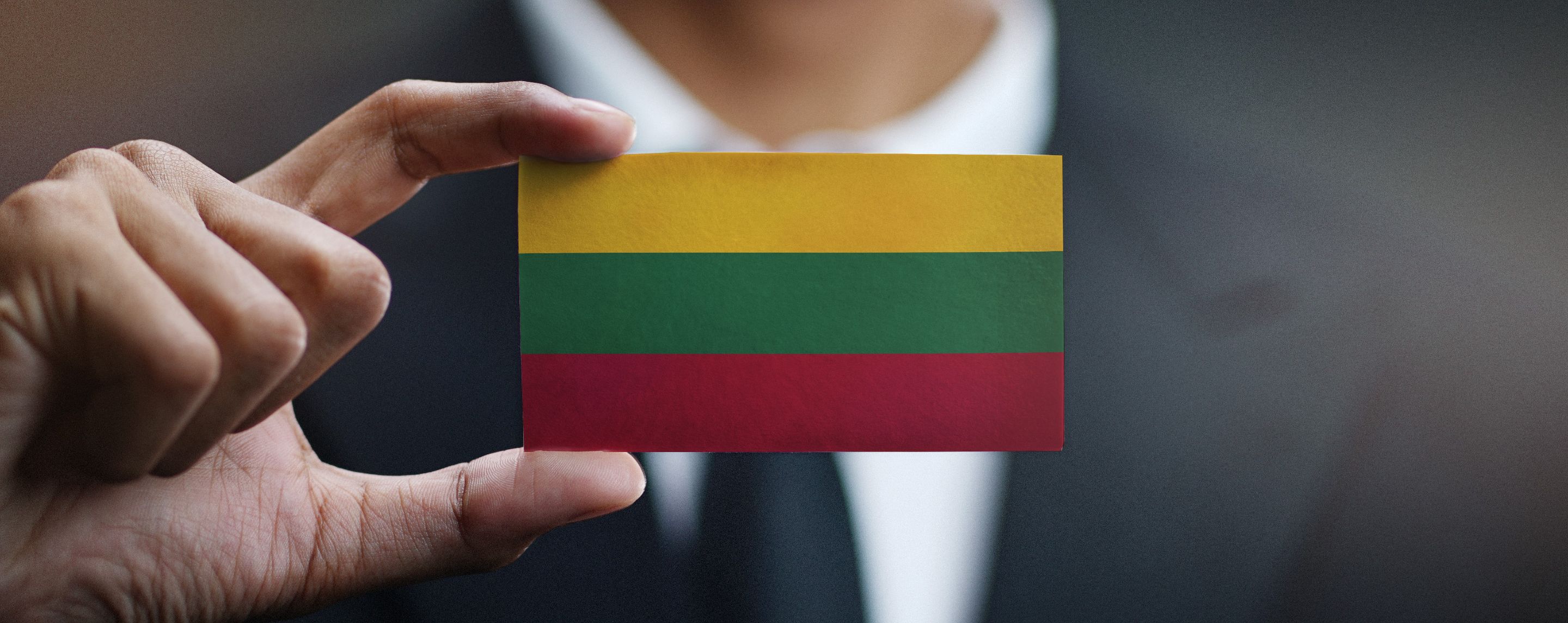 businessman-holding-card-lithuania-flag.jpg