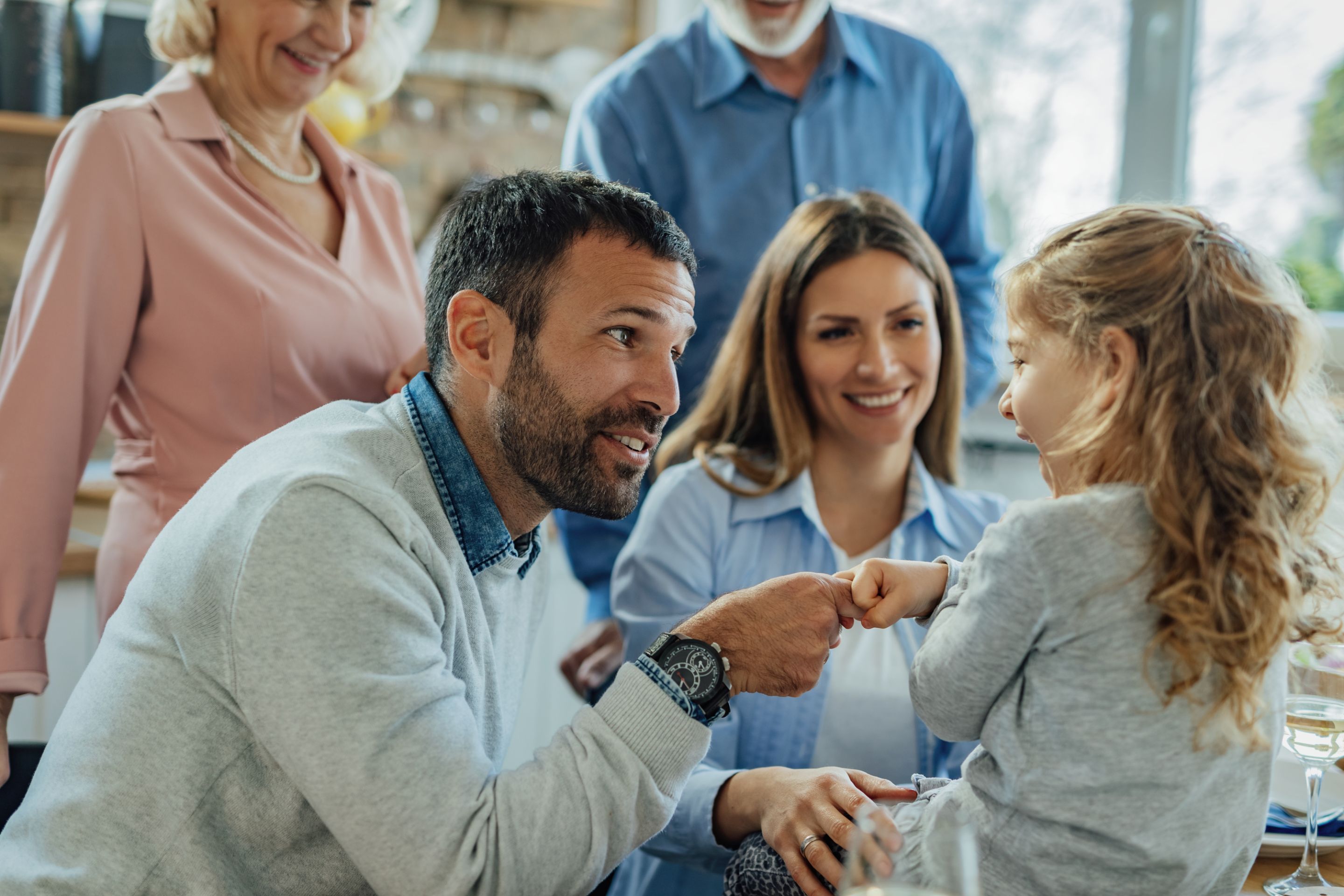 multi-generation-family-enjoying-in-time-together-at-home-focus-is-on-happy-father-talking-to-his-small-daughter-and-making-an-agreement-with-her.jpg