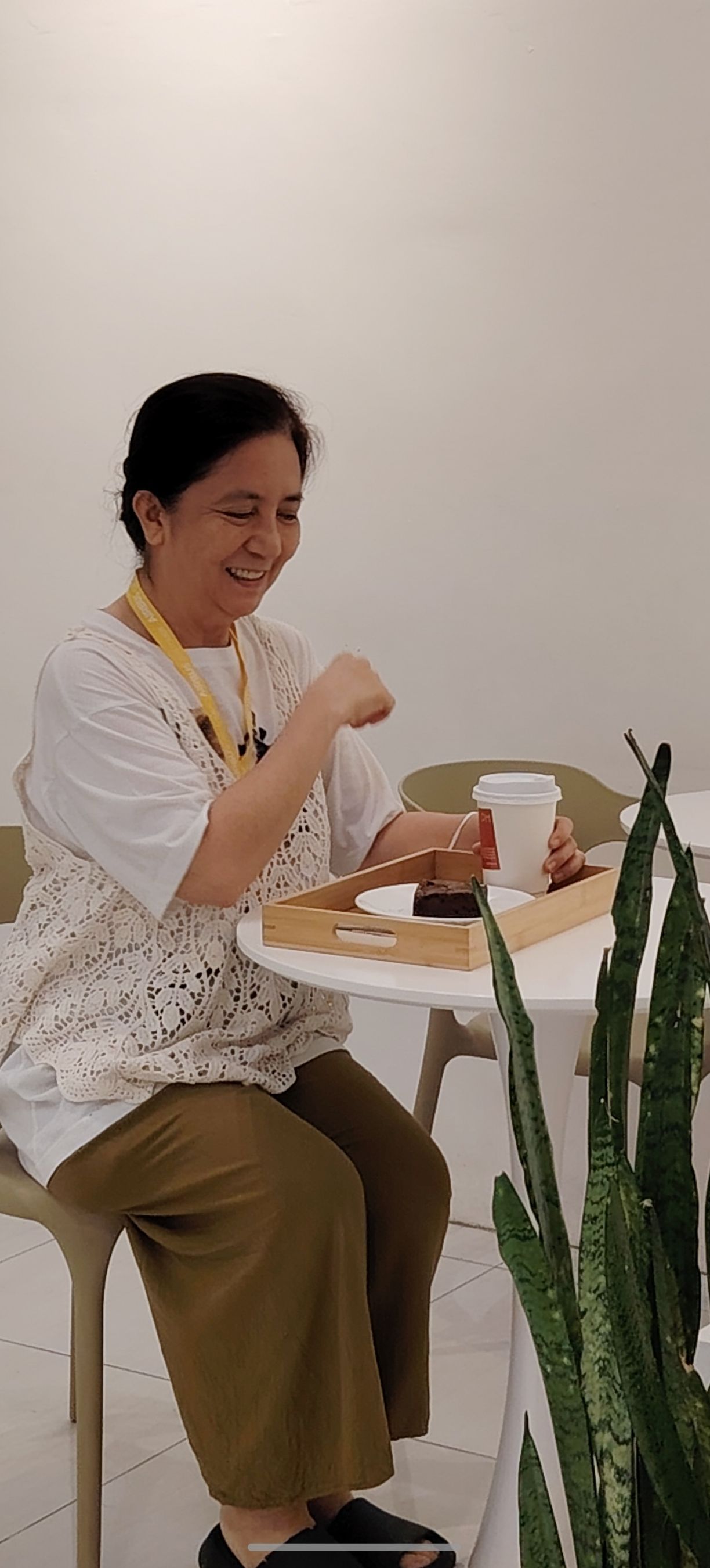 A candid smile over my coffee and brownie.
