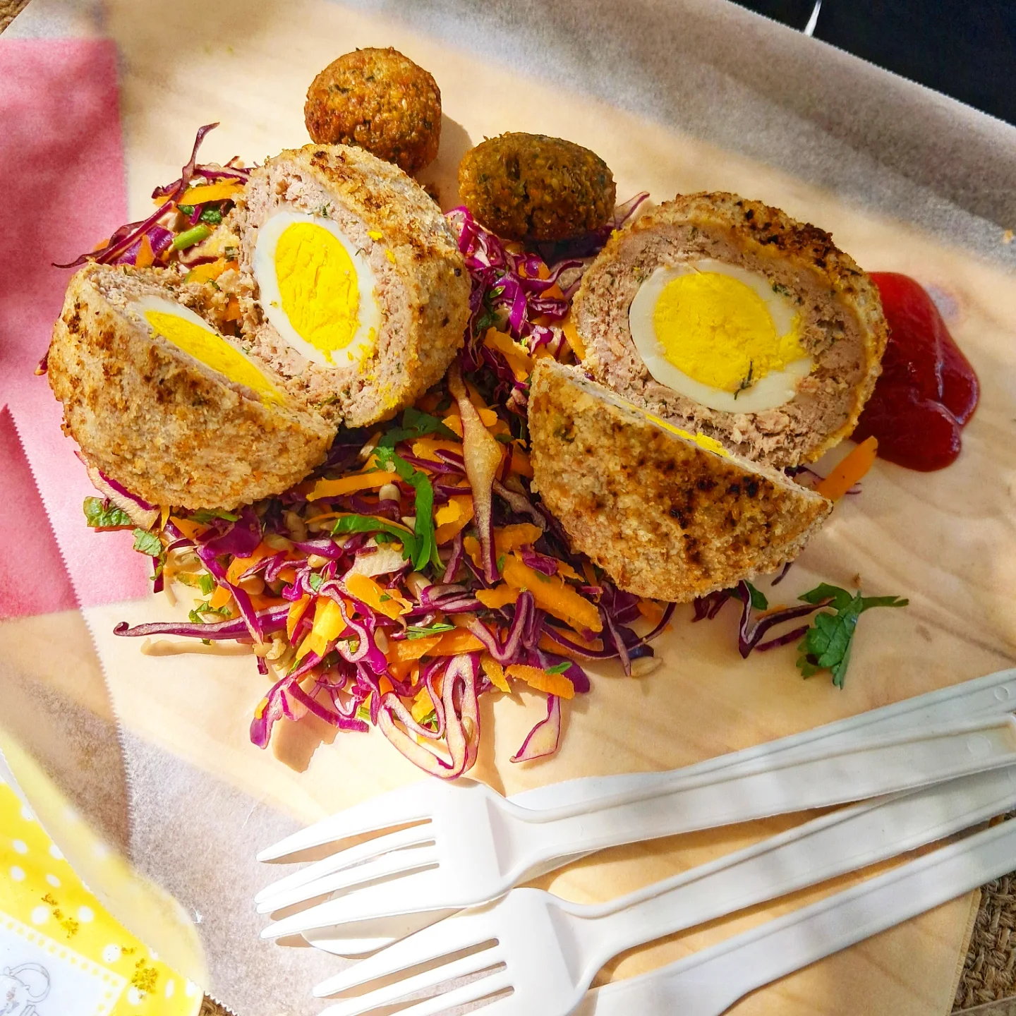 Scotch eggs on rainbow slaw with a couple of falafels on the side
