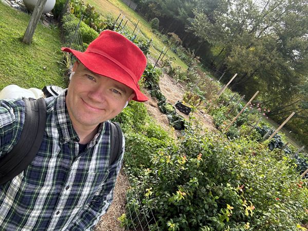 Tom - his dad's hat and shirt by Big garden crop Sept 2025.jpg