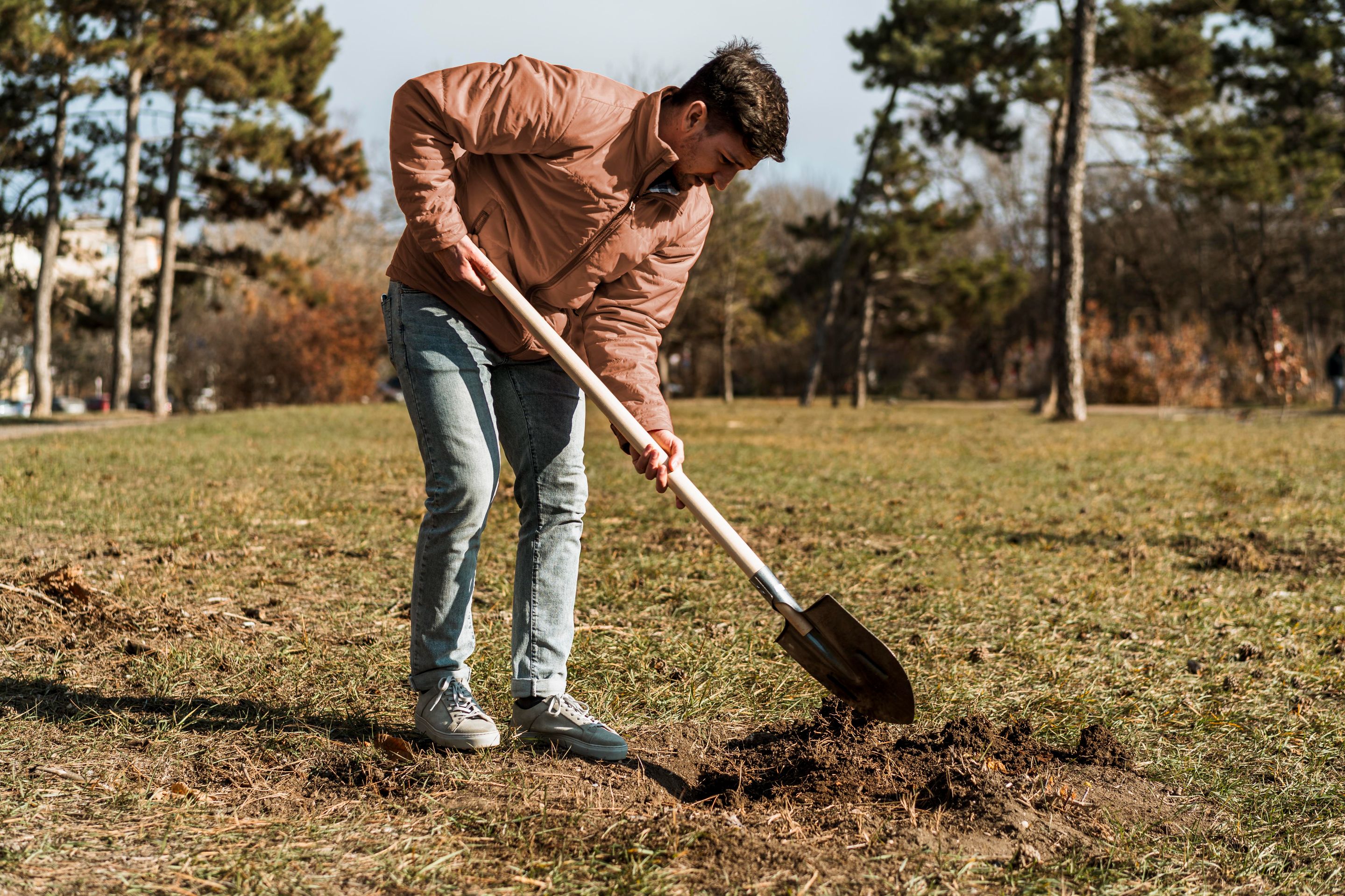 side-view-man-using-shovel-dig-hole-planting-tree.jpg