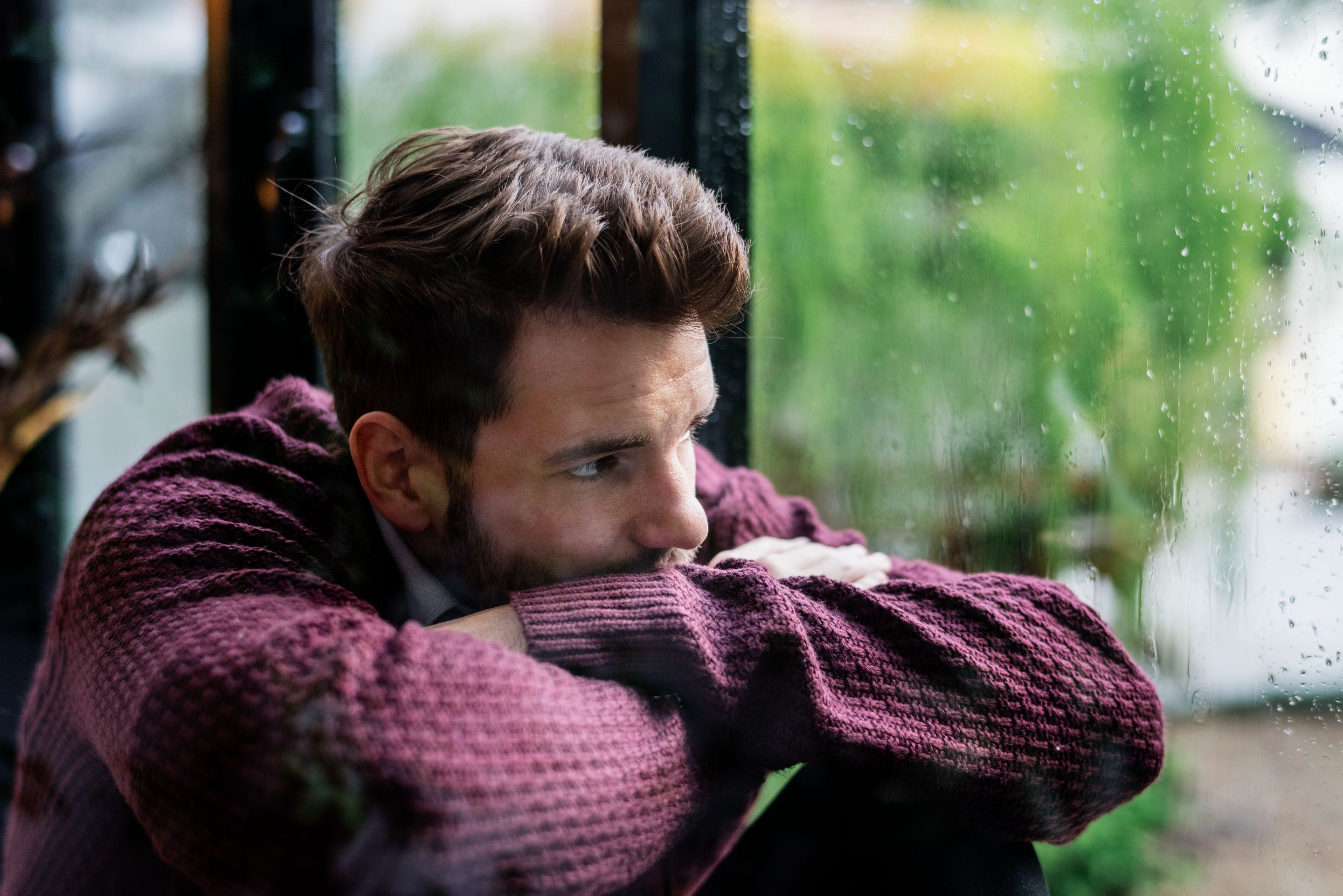 thoughtful-man-looking-out-window.jpg