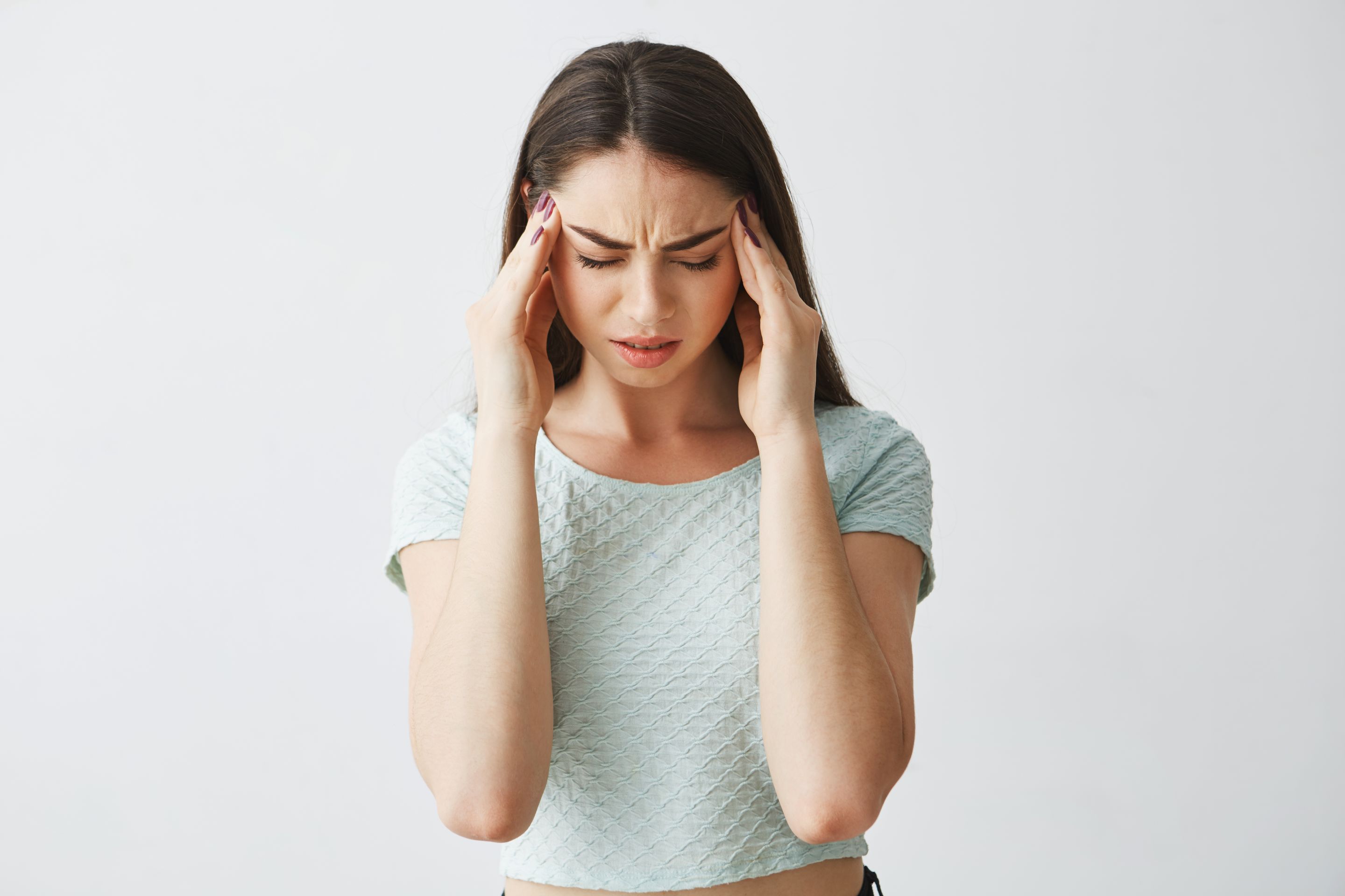young-beautiful-brunette-girl-frowning-touching-temples-headache-isolated-white-background.jpg
