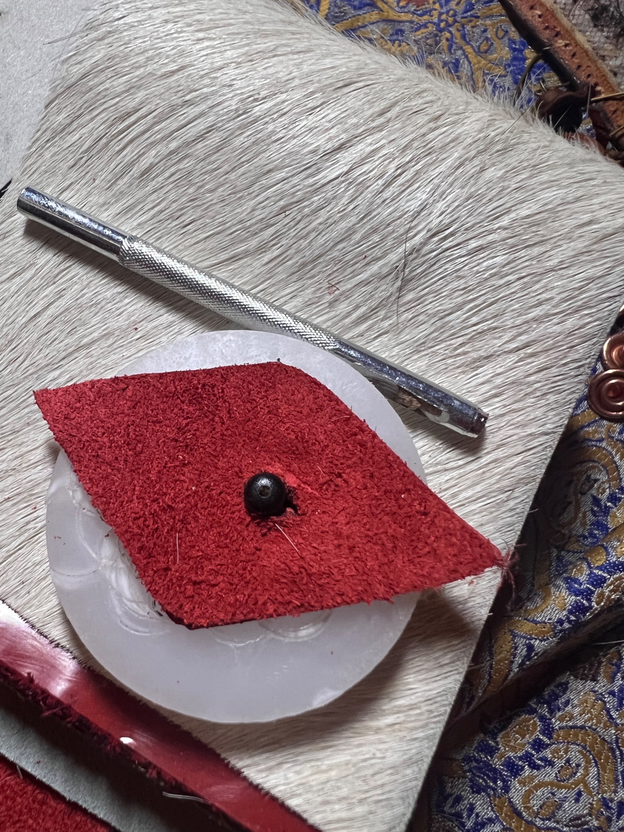 Back: Cut the hole for the closing system on the closing button:)