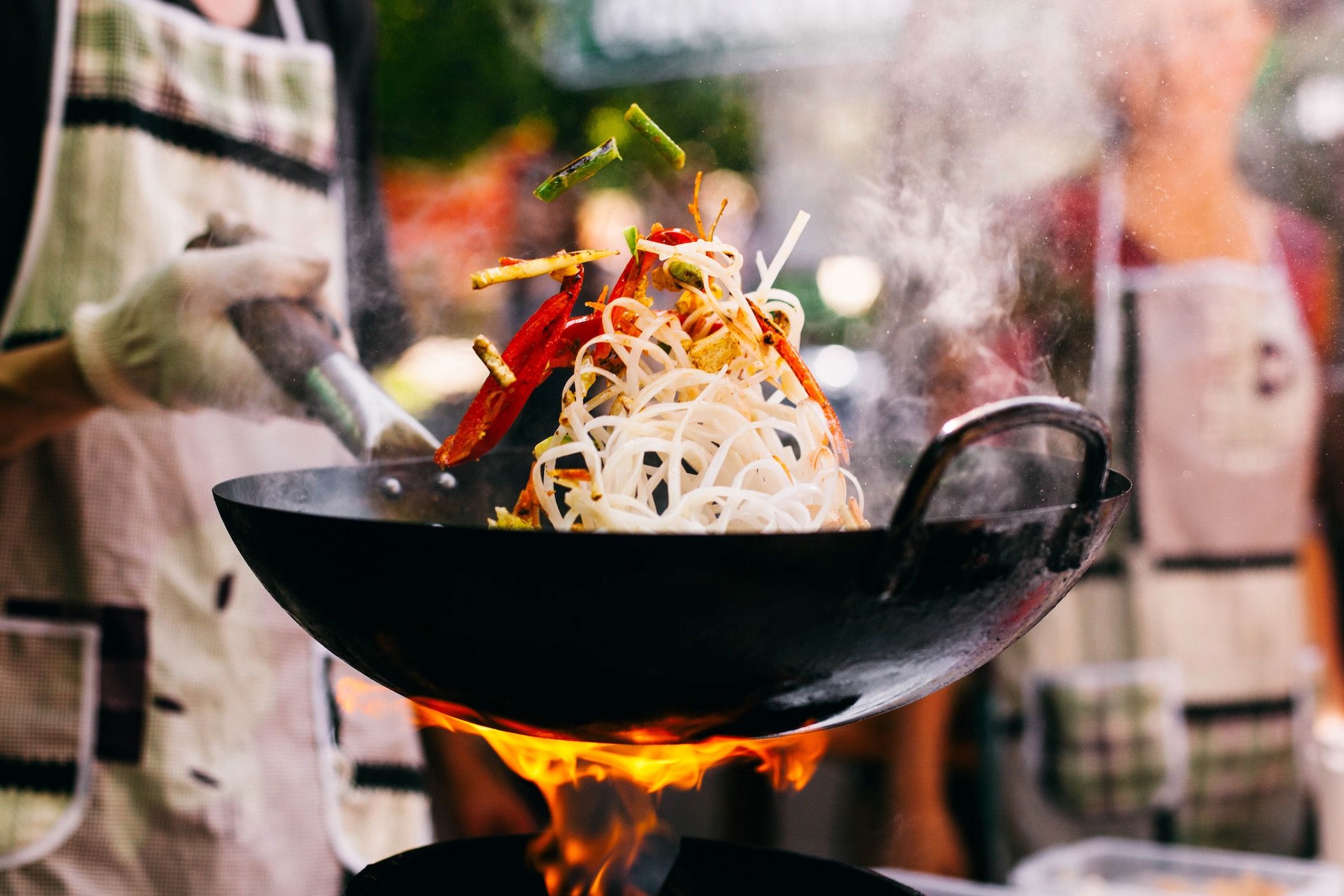 chef-preparing-food-in-wok.jpeg