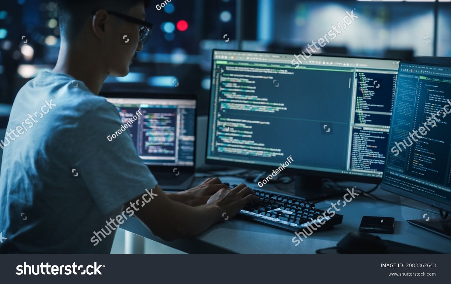 stock-photo-night-office-young-handsome-man-in-working-on-desktop-computer-digital-entrepreneur-typing-code-2083362643.jpg