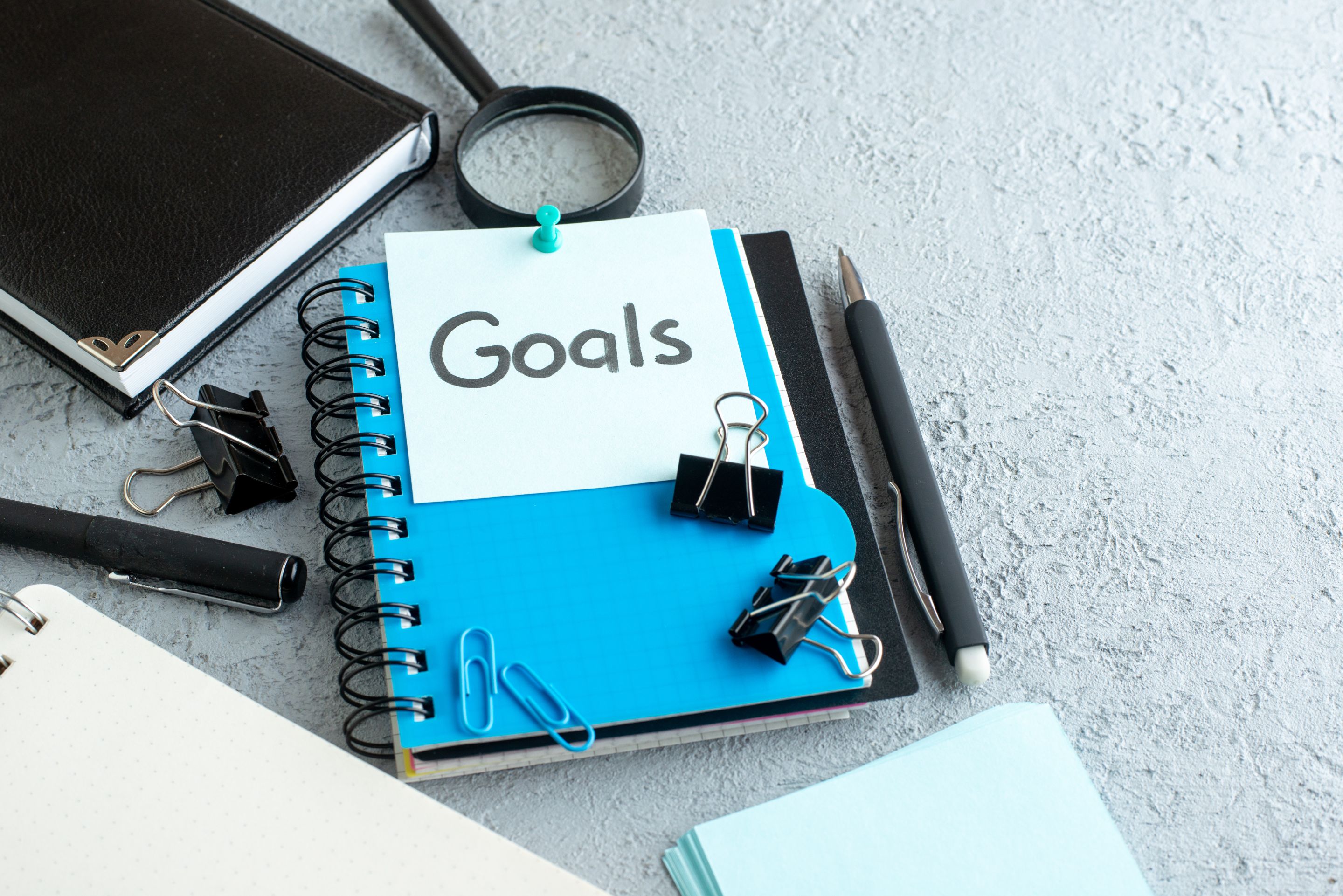front-view-goals-written-note-with-notepad-pen-white-background.jpg