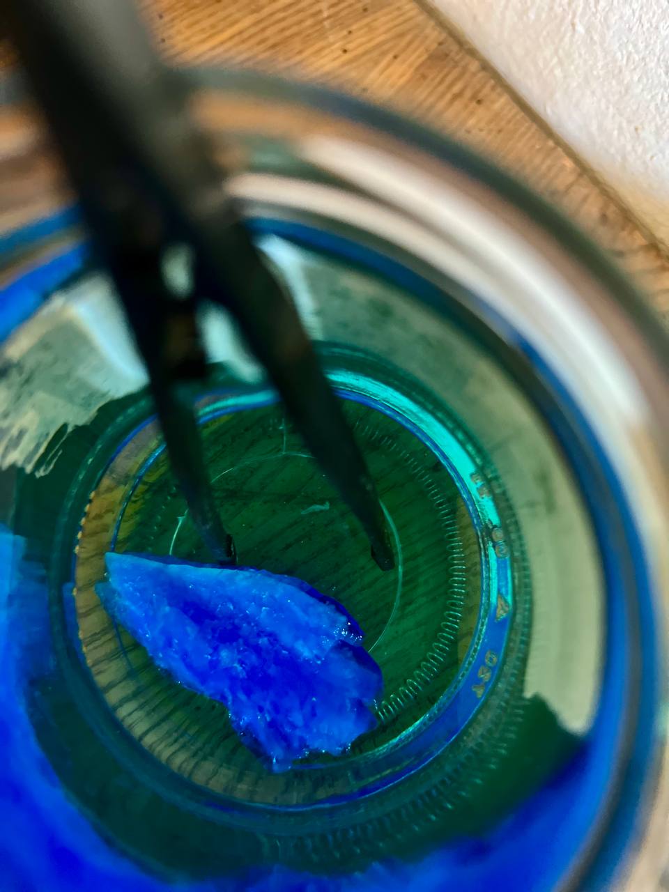 Copper Sulfate Solution being mixed, you can still see the big sulfate crystal that was eventually dissolved