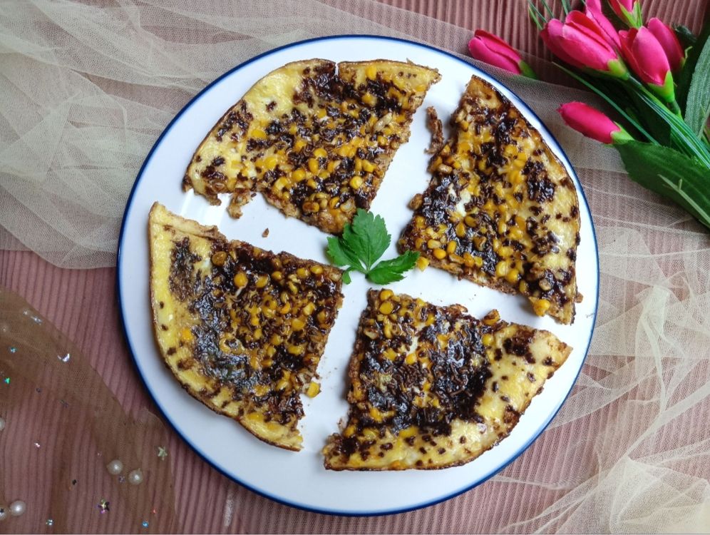 First time making corn pizza with chocolate sprinkles as a topping