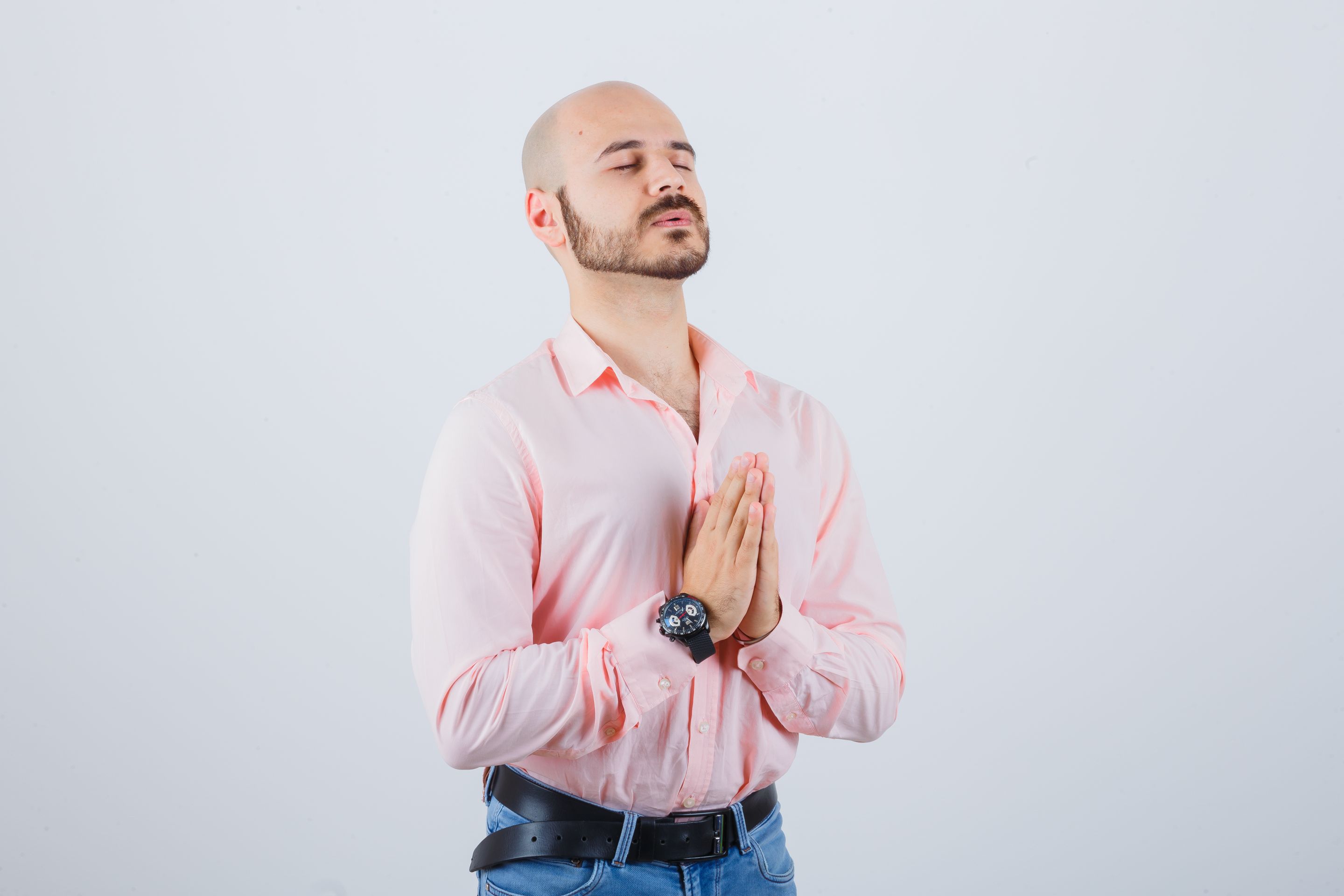 young-man-pink-shirt-jeans-praying-looking-wishful-front-view (2).jpg