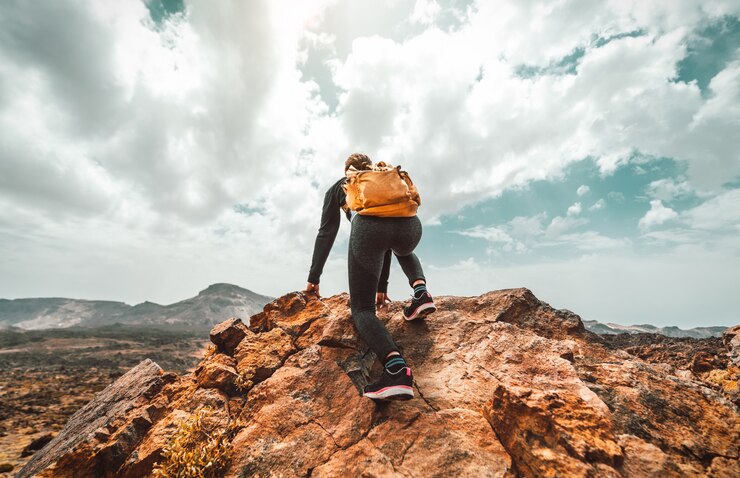 successful-hiker-woman-with-backpack-top-mountain-looking-skyline_169160-174.jpg