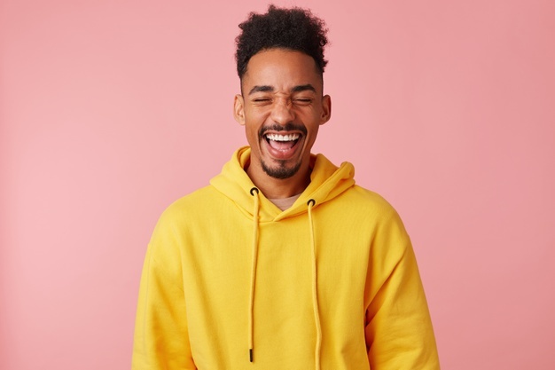 young-happy-smiling-african-american-guy-yellow-hoodie-heard-very-funny-joke-laughed_295783-2454.jpg